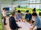 Cika4d team collaborating in a modern indoor agriculture facility, designing innovative vertical farming systems with vibrant greenery.