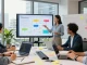 Build internal tools with AI in a collaborative office workspace showcasing diverse professionals presenting innovative solutions.