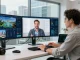 Investor exploring rokok88 virtual properties on digital screens in a modern workspace.